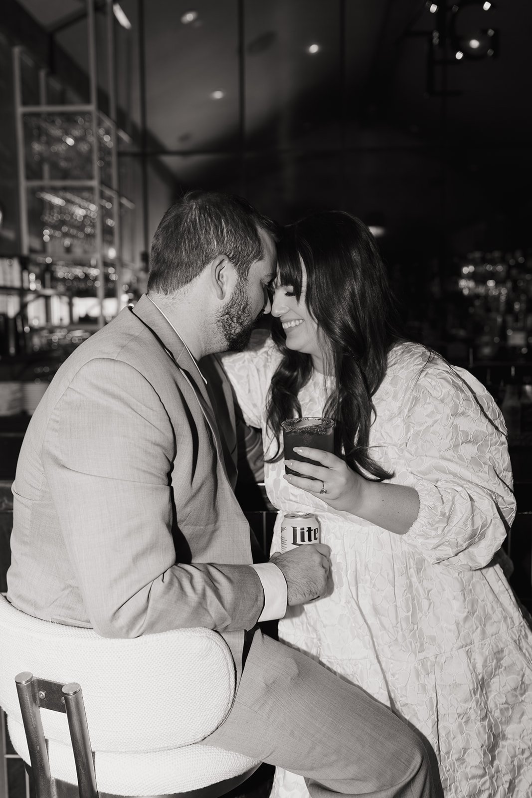 Black and white photo of the couple drinking at the bar