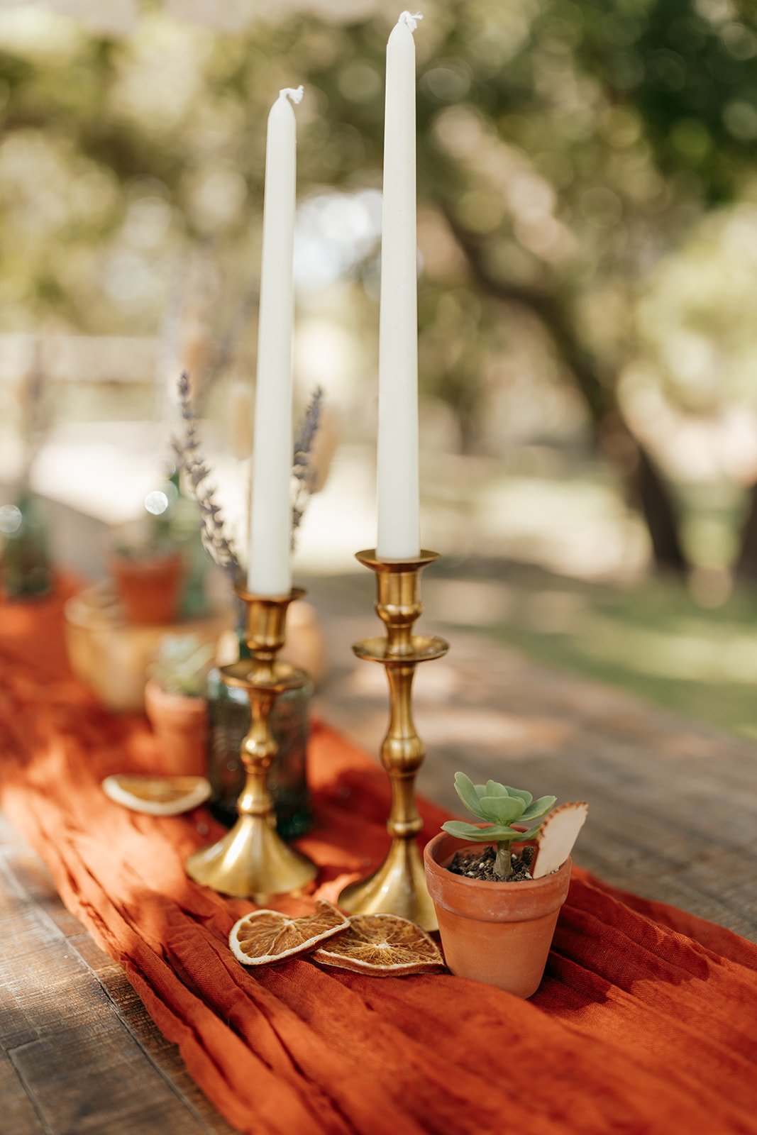 Stunning brass candle holders on their intimate wedding table setting
