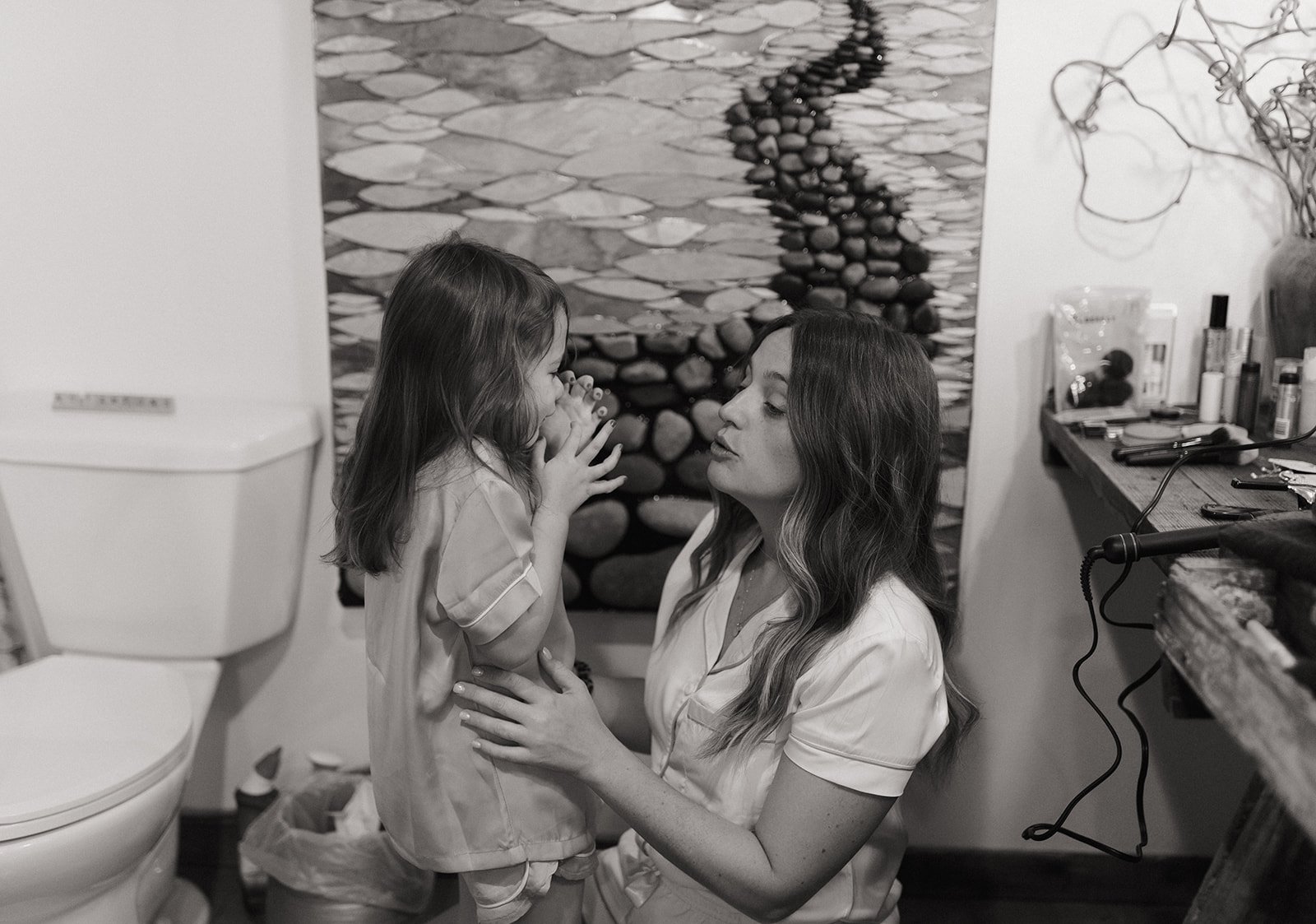 Black and white photo of Leah helping her daughter get ready for the wedding