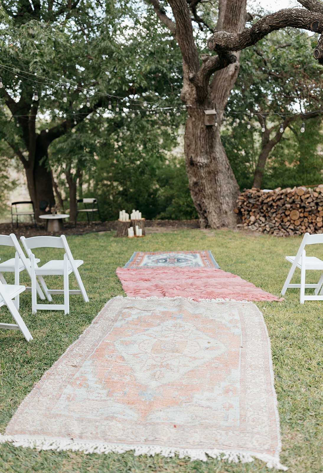 Bohemian-inspired rugs make up the aisle of the intimate outdoor wedding location