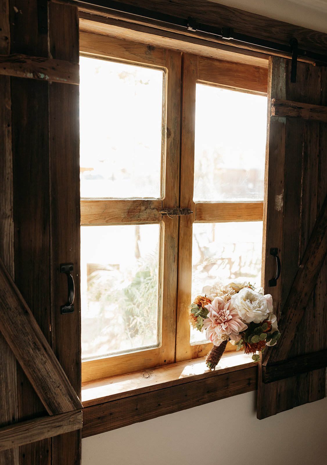 Timeless wooden shutters frame the light-filled windows