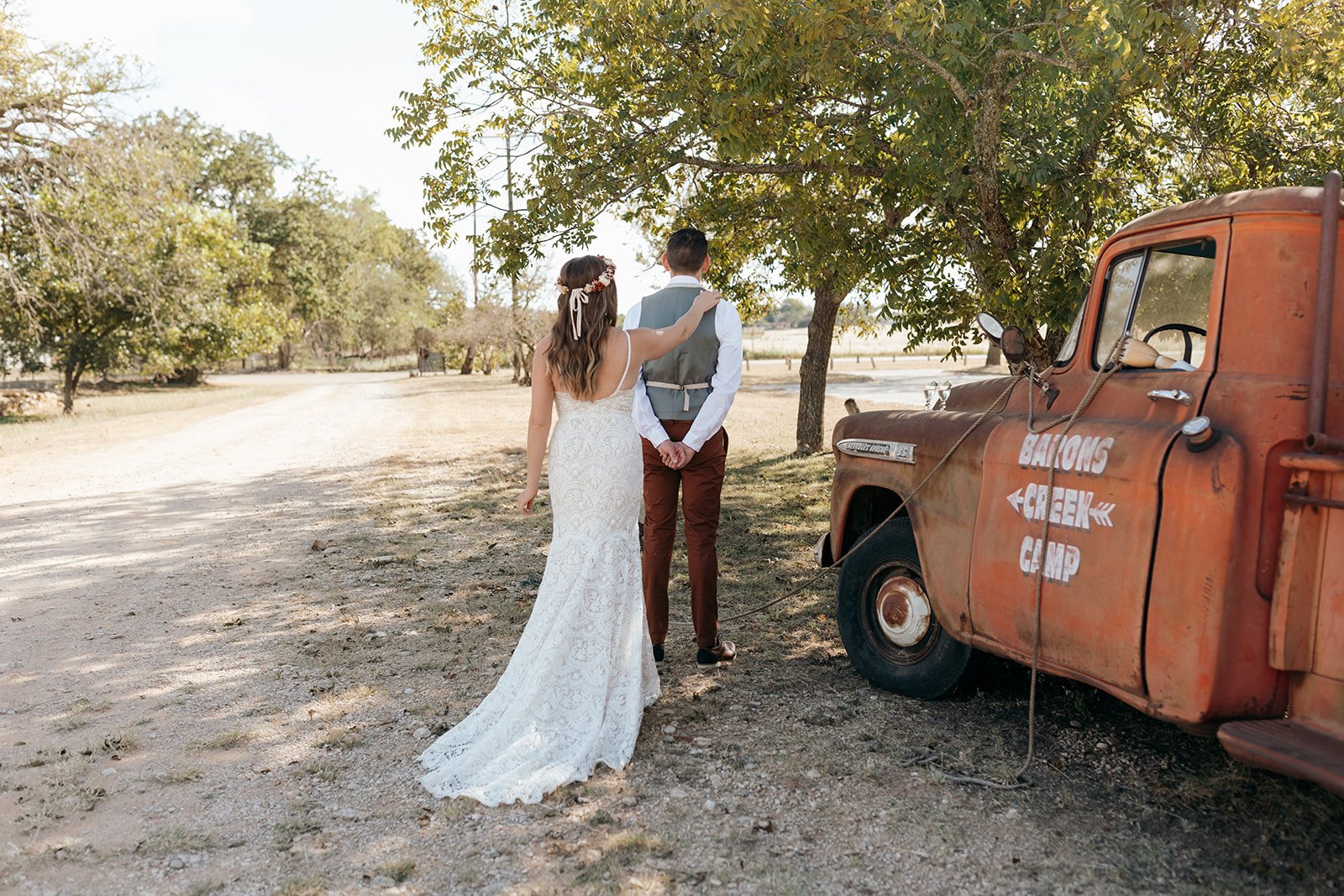James and Leah's first look near the Baron's Creek Camp vintage red pickup truck