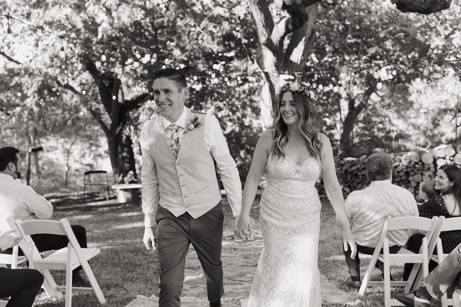 Black and white photo of the couple walking down the aisle as husband and wife