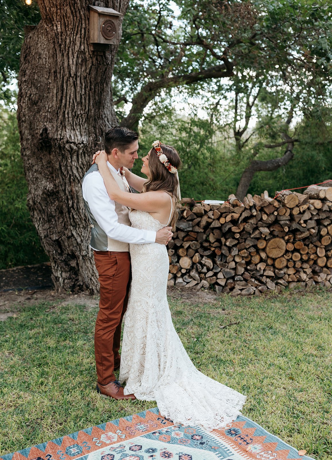 Leah and James embracing at the intimate outdoor ceremony site at Baron's Creek Camp