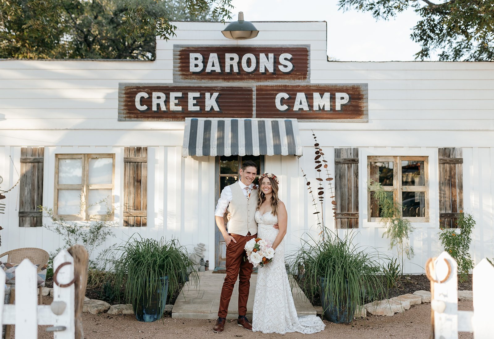 Leah and James in front of Baron's Creek Camp main lodge in Fredericksburg, TX