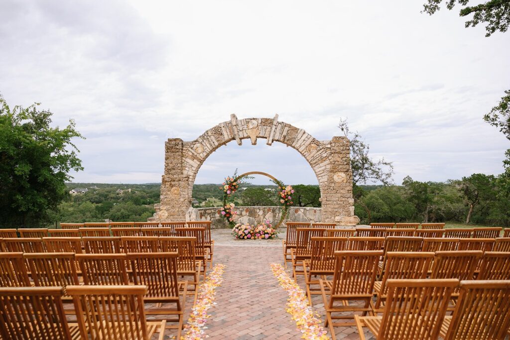 Camp Lucy's stone arch outdoor wedding ceremony space with gorgeous Hill Country views in Dripping Springs Texas