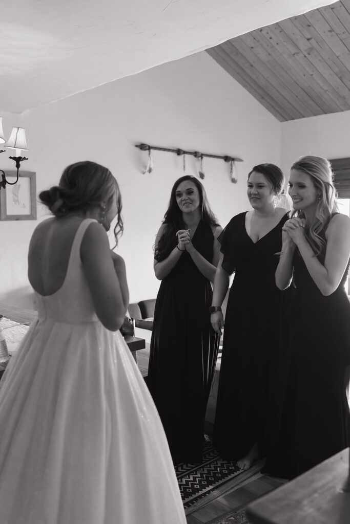 Candid first look moment with the bride and her bridesmaids