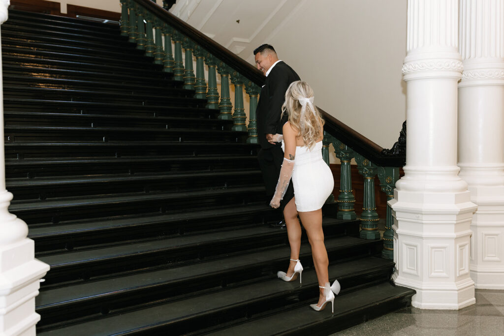 Elegant engagement photos on the staircase inside the Texas State Capitol