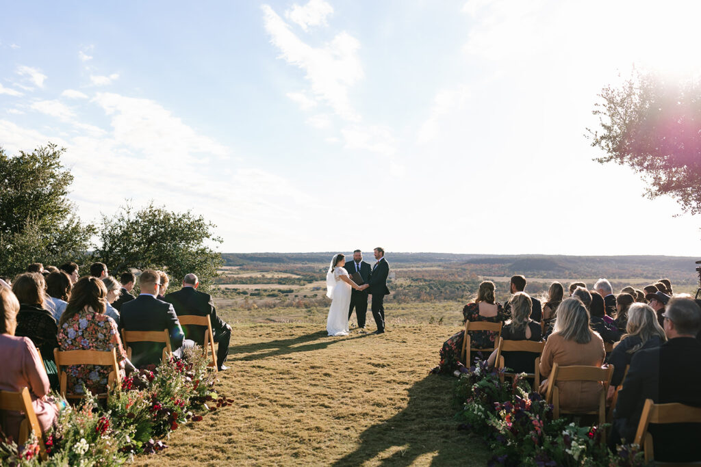 Scenic outdoor wedding ceremony at Contigo Ranch's The Bluff wedding site
