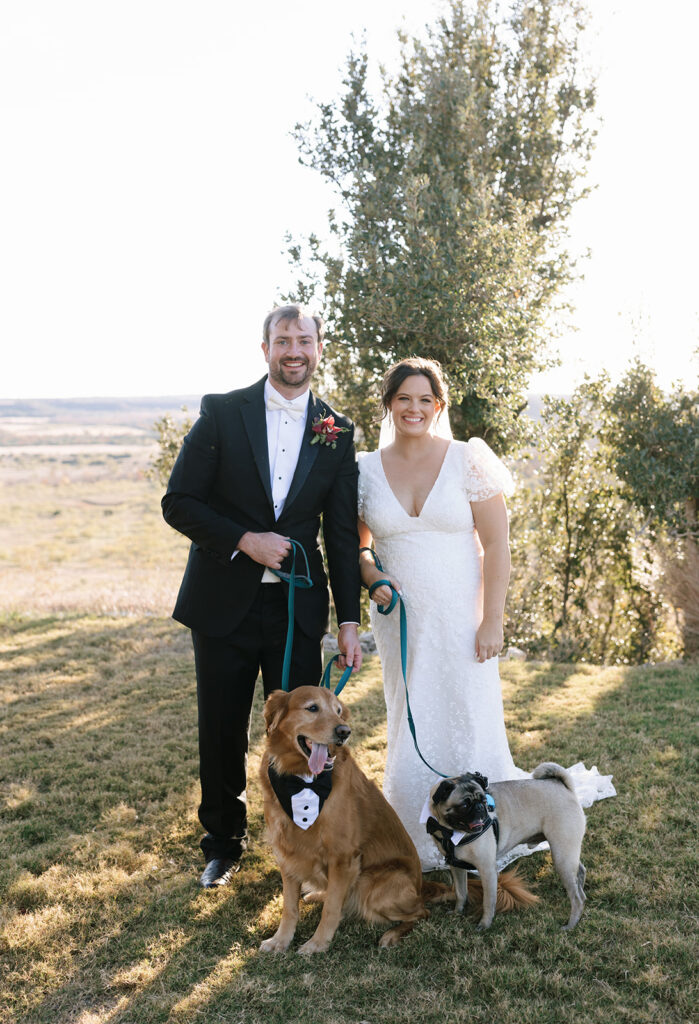 The couple taking wedding portraits with their doggos