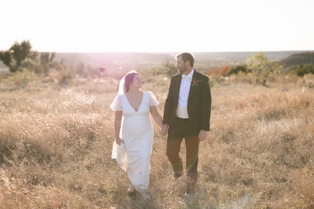 Stunning and ethereal golden hour wedding portraits in a field of prairie grass at Contigo Ranch