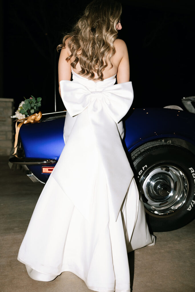 Flash photo close-up of Lara's gorgeous dress with the large wedding bow