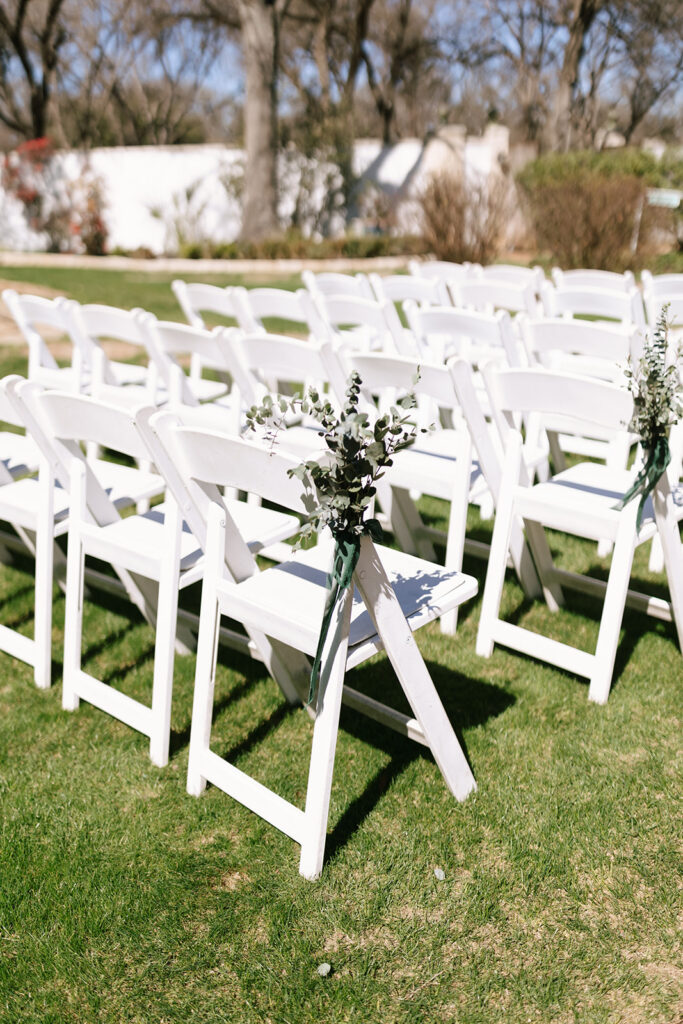 Small eucalyptus sprigs accenting the intimate outdoor garden wedding aisle
