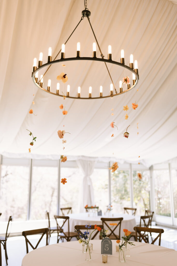 The ethereal white curtains and chandeliers at Hummingbird House Austin hung with floating florals