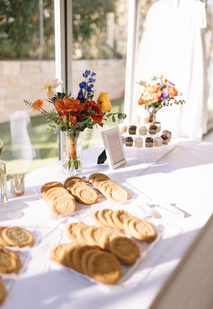 Cookies and other garden party treats during the reception under the white, light-filled canopy space