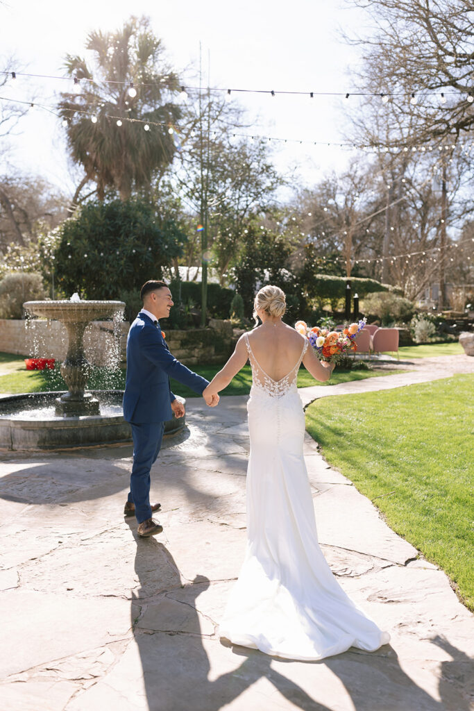 The couple leaving the outdoor ceremony along the gorgeous garden path at Hummingbird House Austin
