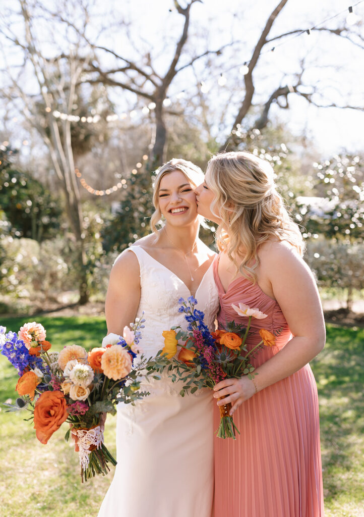 Bryn portraits with her sister after the ceremony at Hummingbird House Austin gardens