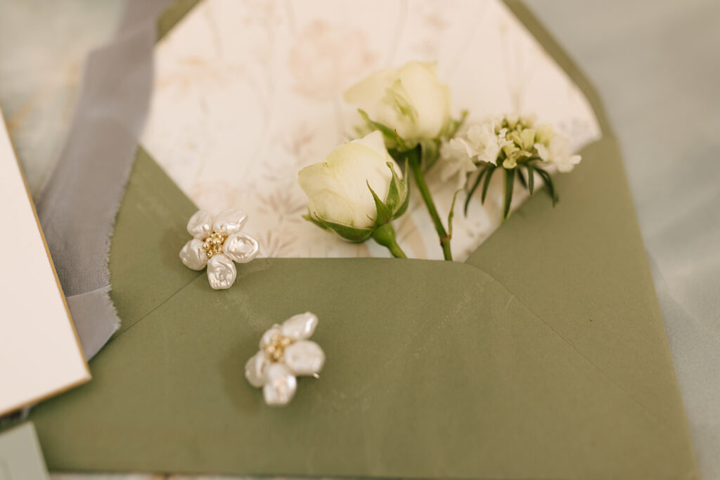 Romantic green and blue wedding flat lay details