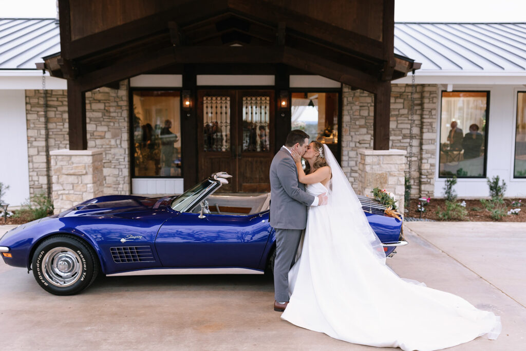 Couples wedding portrait next to a classic Corvette at the Videre Estate