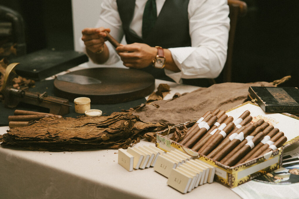 On-site artisan cigar roller to keep guests warm during their romantic winter wedding