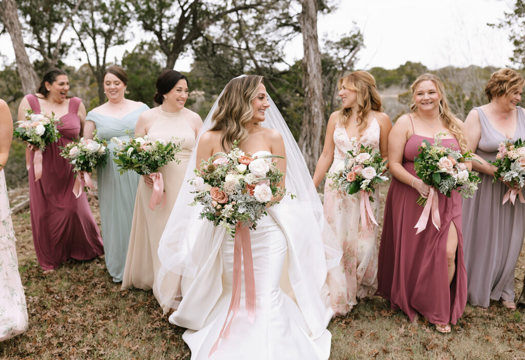 Romantic winter wedding party portraits outside on the grounds of the Videre Estate in Wimberley Texas