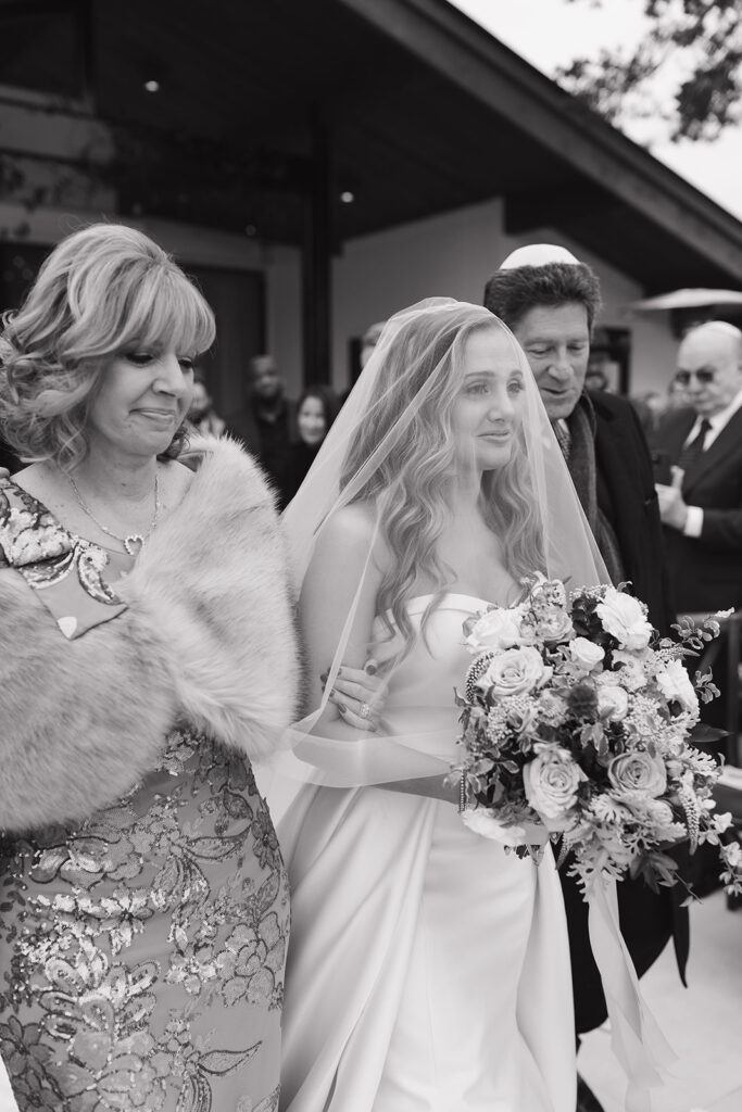 Lara emotional as she walks down the aisle with her mom and dad