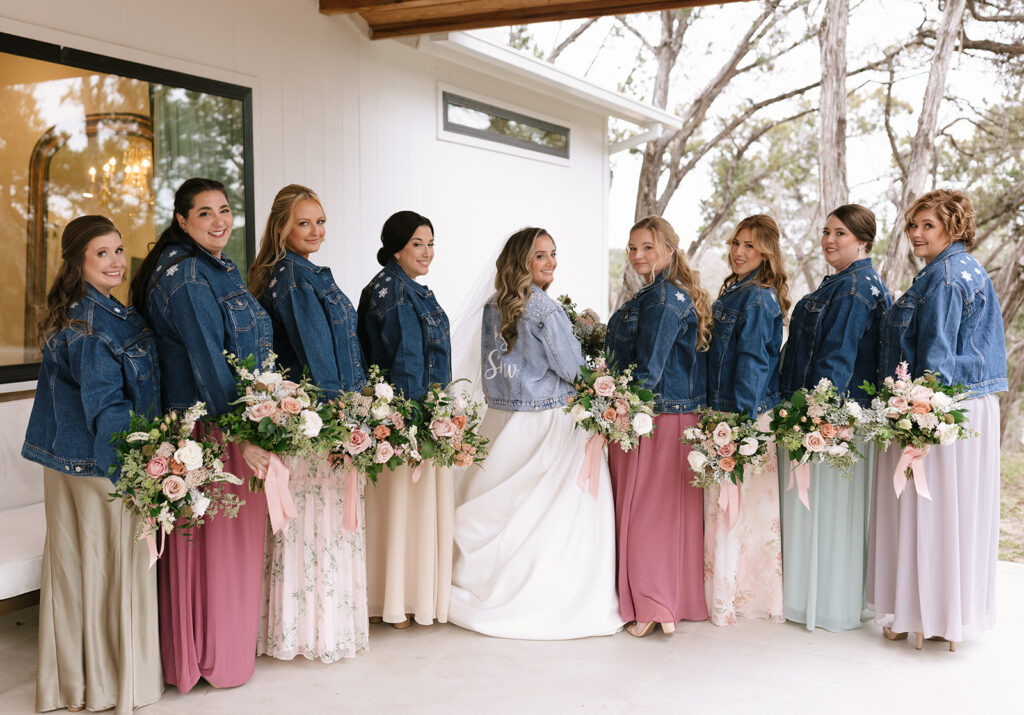 Lara and her wedding party with embroidered denim jackets for a cozy winter wedding idea