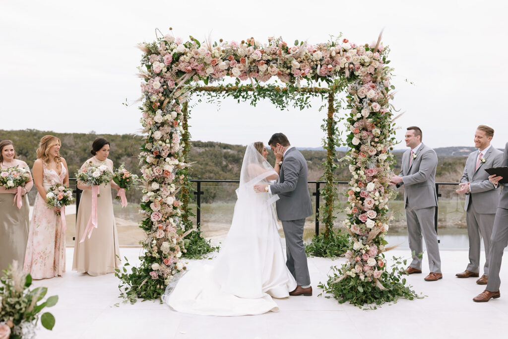 Romantic winter wedding chuppah overflowing with dreamy florals