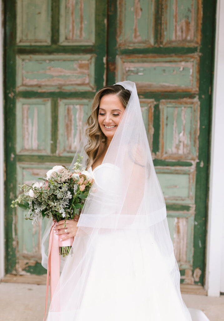 Bridal portraits in front of the vintage green door at the Videre Estate's Château hall.