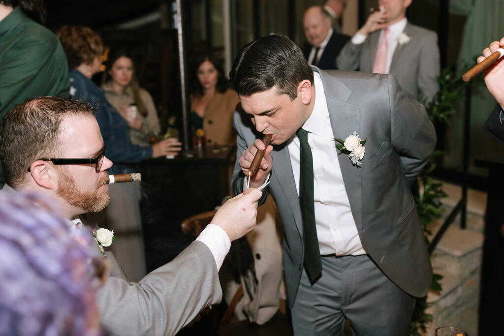 Jordan enjoying a cigar with his groomsmen during the wedding reception