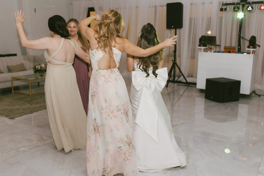 The bride and bridesmaids on the dance floor at the Videre Estate in Wimberley Texas