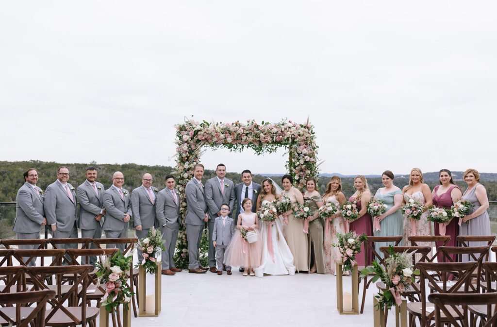 Romantic winter wedding party portrait under the chuppah where they had their outdoor winter wedding ceremony at the Videre Estate's overlook deck