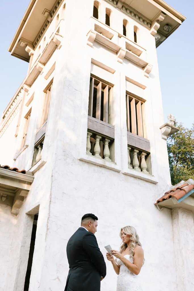 Bride and groom exchanging private vows outside Villa Antonia tower