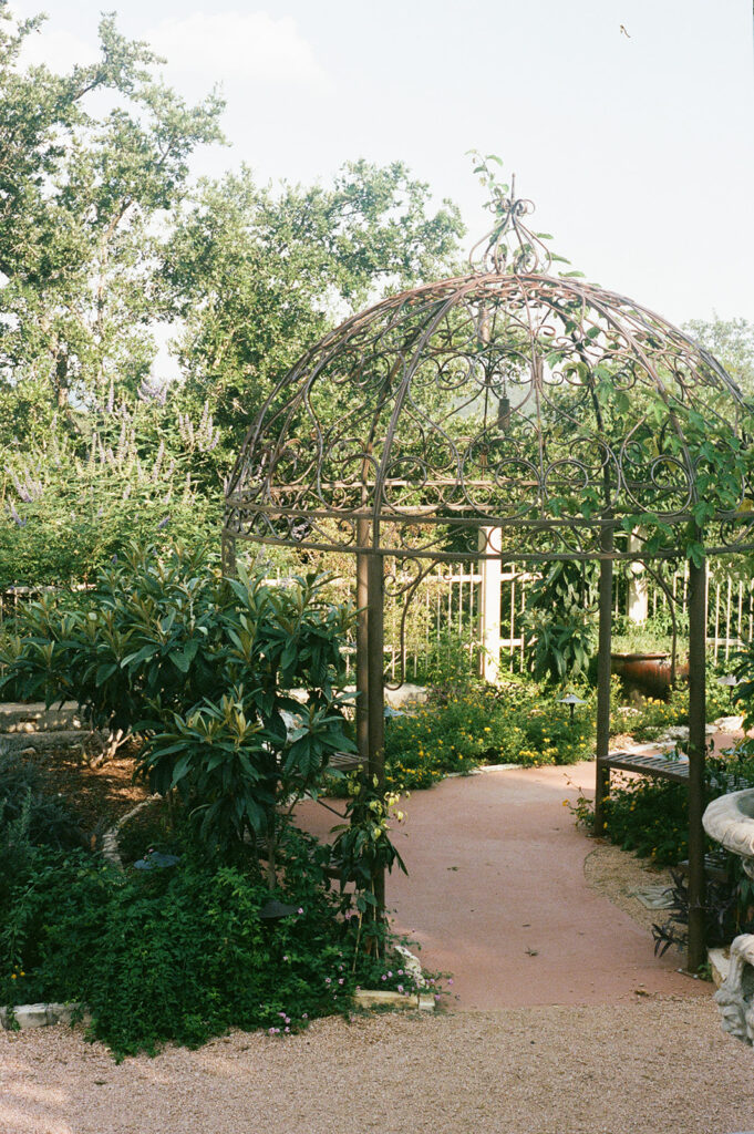 Garden pathway with gazebo and lush landscape at Villa Antonia on 35mm film