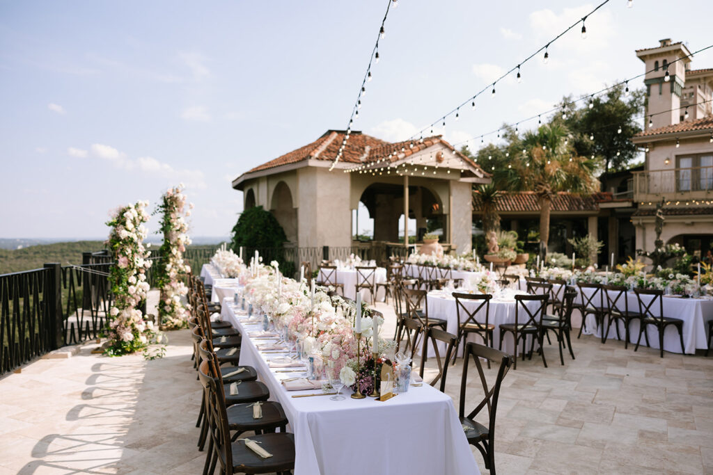 Classy and timeless Villa Antonia wedding reception in their courtyard under string lights and with panoramic Hill Country Austin Texas views