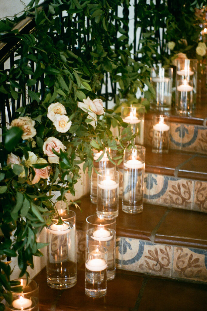 Candles and greenery lining the stairs for a romantic ambiance at their Villa Antonia wedding