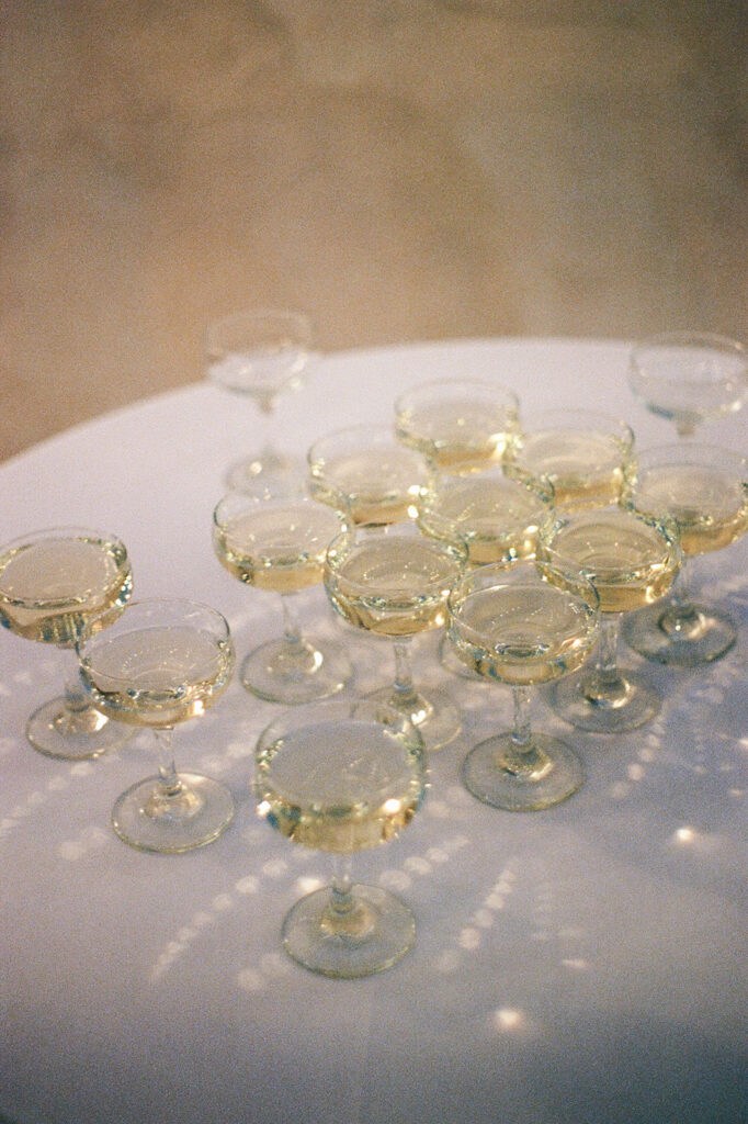 Champagne glasses arranged elegantly for Villa Antonia wedding celebration, captured on 35mm film