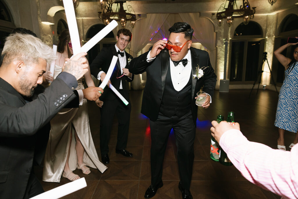 Groom and guests enjoying the dance floor, celebrating at Villa Antonia wedding reception