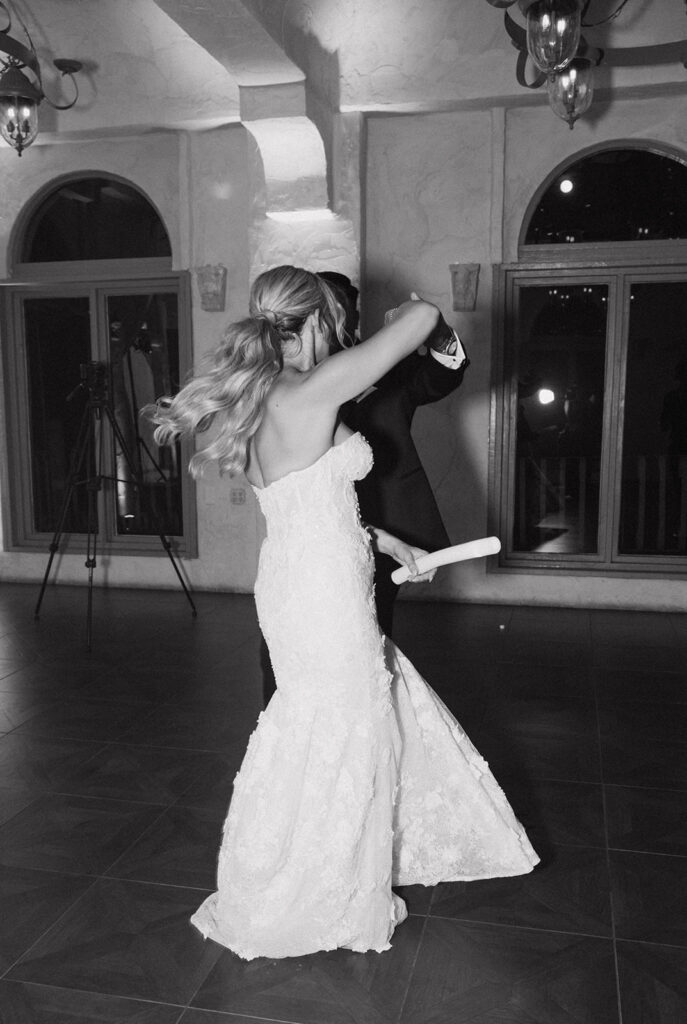 Groom spinning the bride around on the dance floor