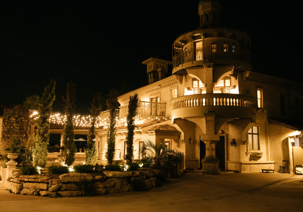 Night view of Villa Antonia, elegantly lit for a wedding reception.