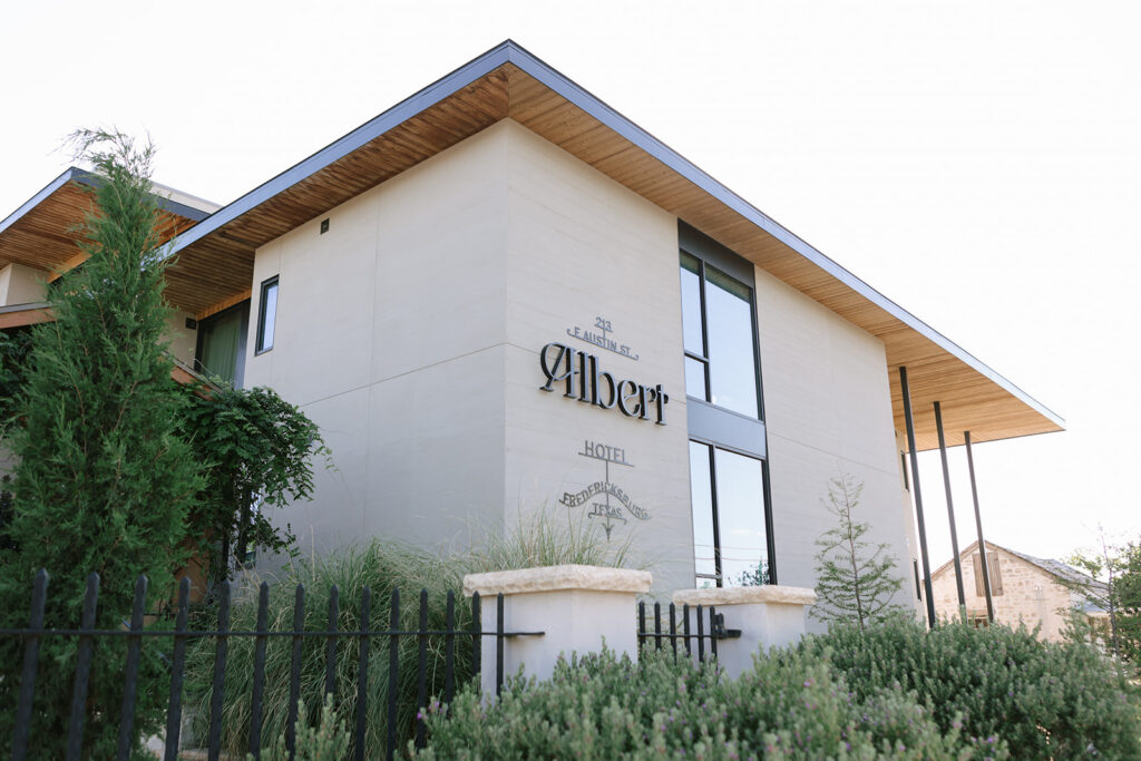 Exterior of Albert Hotel Fredericksburg with its modern, architectural design under soft afternoon light.