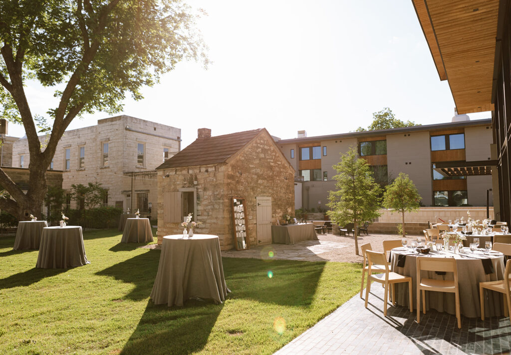 The historic and modern courtyard cocktail hour reception space at the newly renovated Albert Hotel in downtown Fredericksburg Texas