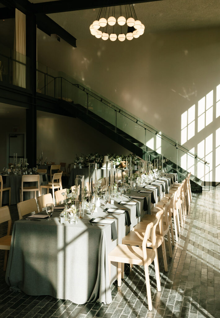 Indoor reception tables lined in symmetry under soft window light at Albert Hotel Fredericksburg.