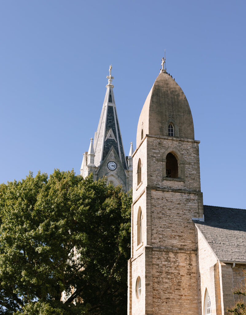 Twin steeples and limestone exterior of St. Mary’s Catholic Church in Fredericksburg, a historic and iconic Hill Country wedding ceremony location.