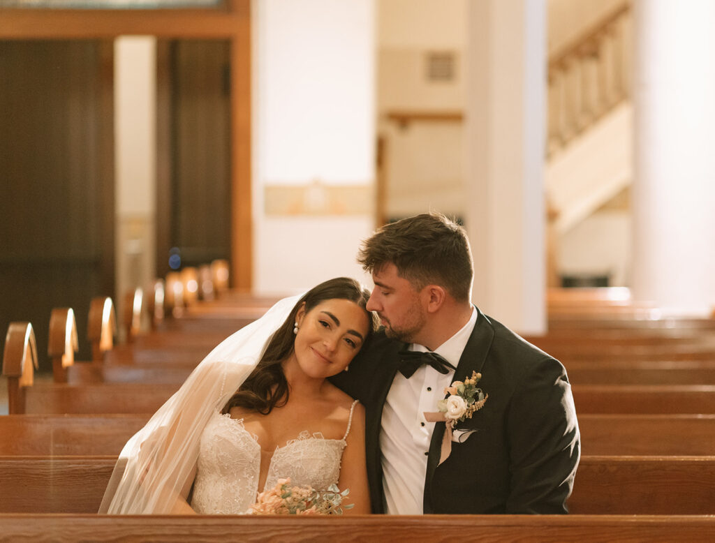 Sunset-lit portrait of Shannon and Austin holding each other at the altar inside St. Mary’s, warm light filling the cathedral-style space behind them.
