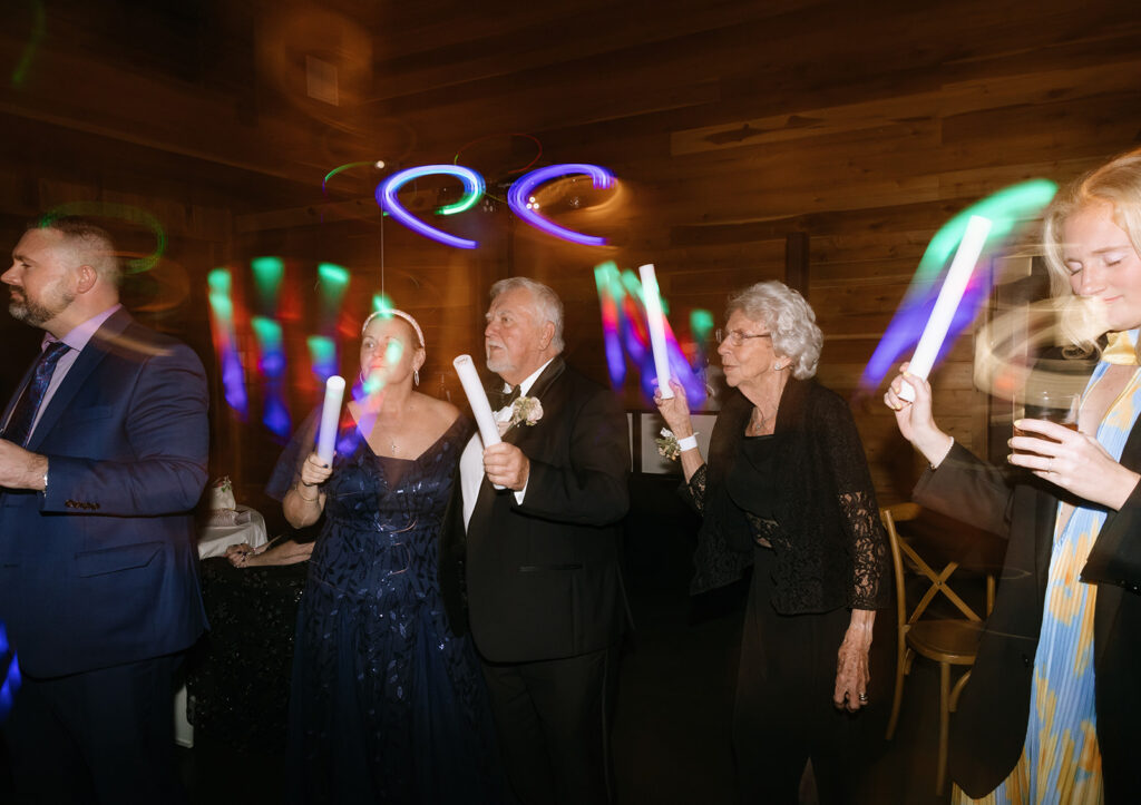 Guests of all ages—including grandparents!—waving glow sticks and dancing late into the night at this joyful Fredericksburg Texas wedding.